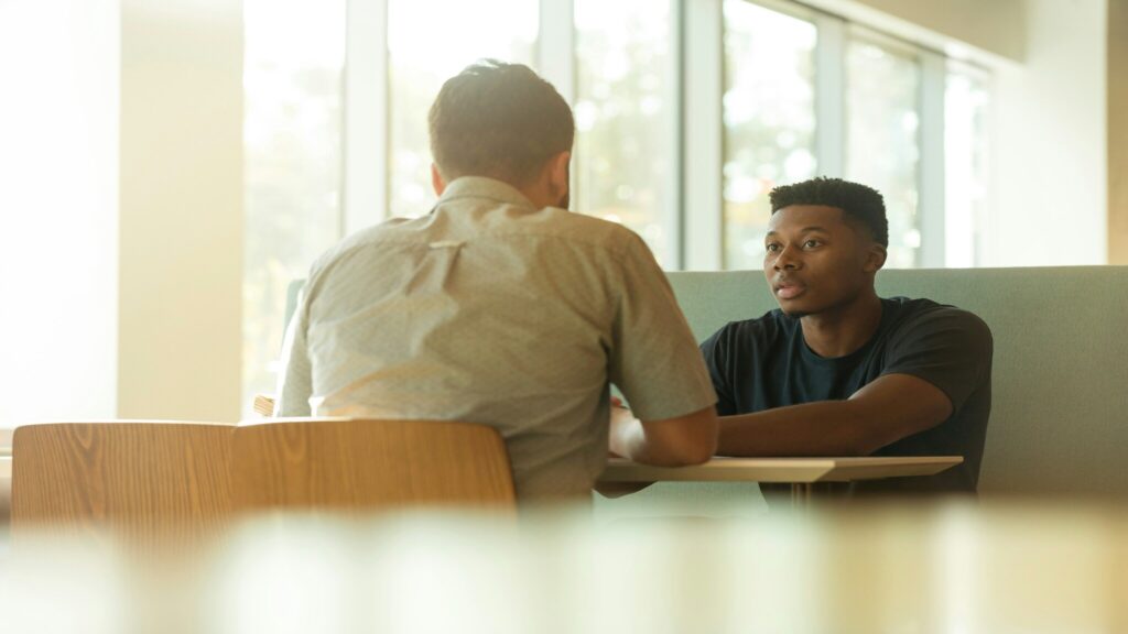 Client having a one-on-one conversation with a therapist during an in-person counseling session