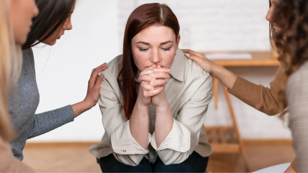 Woman experiencing anxiety while receiving emotional support