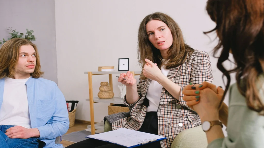 Social anxiety therapist explaining treatment strategies during a counseling session with clients